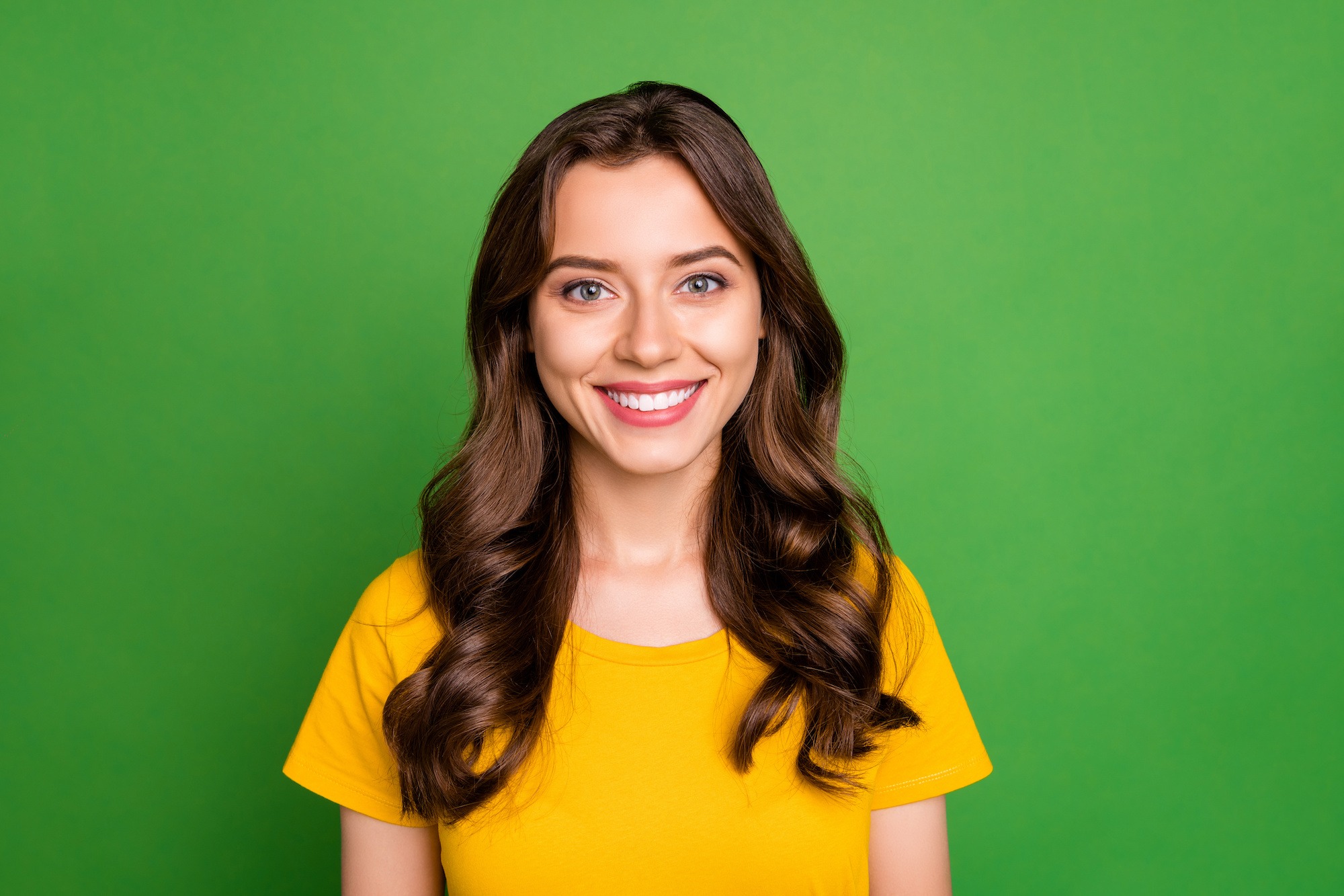 Close-up portrait of her she nice attractive lovely pretty cute cheerful cheery wavy-haired girl college high school student isolated over bright vivid shine vibrant green color background orthodontist west chester ohio